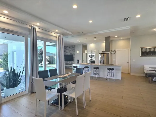 a dining room with furniture and a view of kitchen