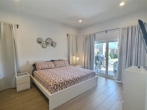 a bedroom with a large bed and a window