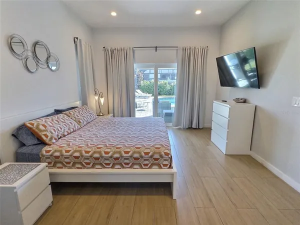 a bedroom with a bed and a flat screen tv