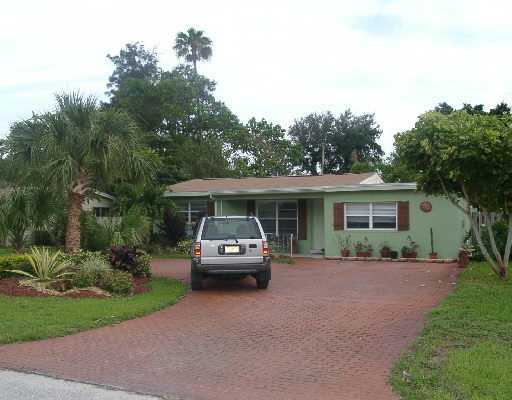 124 Northwest 10th Street Boca Raton, FL 33432 - Photo 1 of 16 a house view with a garden space