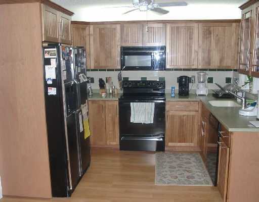 124 Northwest 10th Street Boca Raton, FL 33432 - Photo 11 of 16 a kitchen with stainless steel appliances granite countertop a refrigerator stove and sink