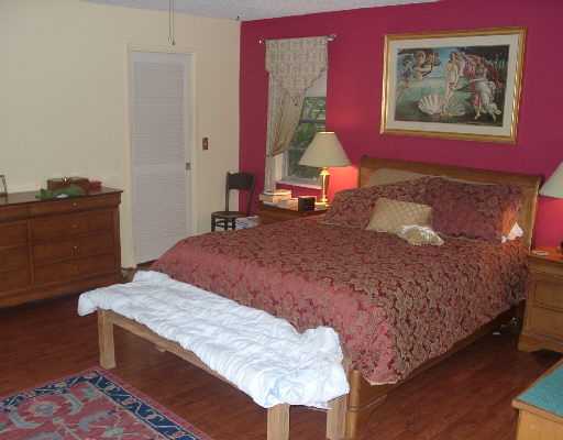 124 Northwest 10th Street Boca Raton, FL 33432 - Photo 5 of 16 a bedroom with a bed and a dresser