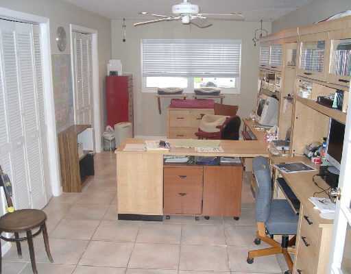 124 Northwest 10th Street Boca Raton, FL 33432 - Photo 8 of 16 a kitchen with a sink dishwasher stove and white cabinets