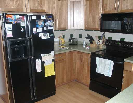 124 Northwest 10th Street Boca Raton, FL 33432 - Photo 10 of 16 a kitchen with a refrigerator and a stove
