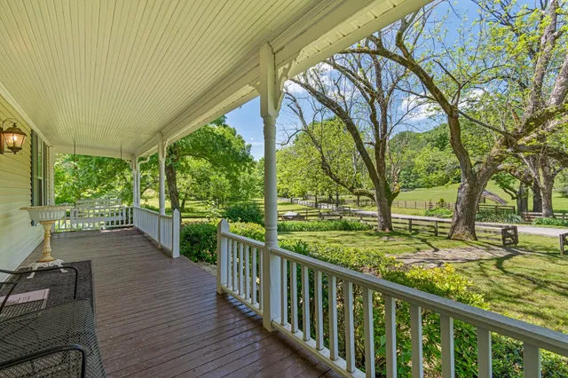 a view of a porch with wooden floor and fence