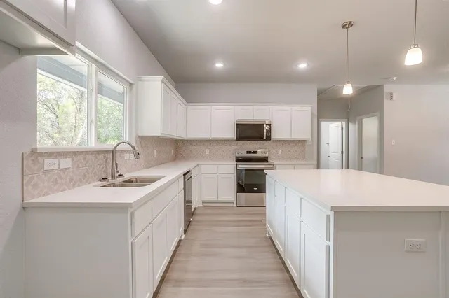 a view of a small space with wooden floor and a window