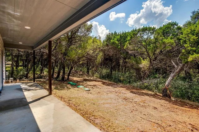 a backyard of a house with large trees