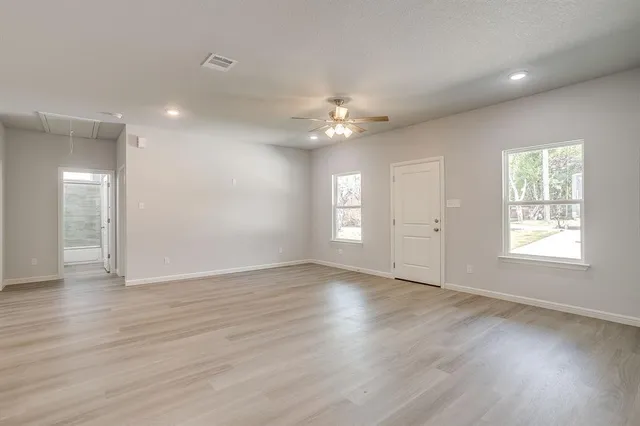 a view of kitchen with refrigerator and window