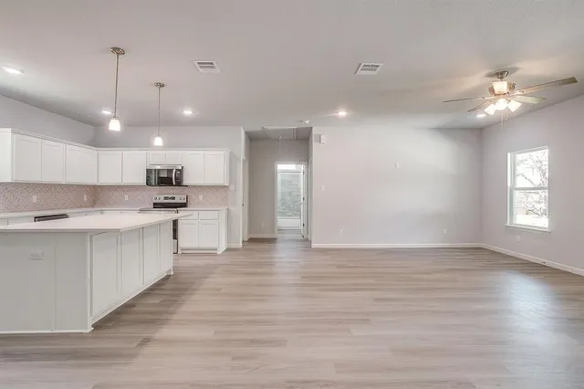 a view of an empty room with a window