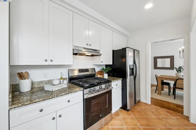 a kitchen with stainless steel appliances a refrigerator stove and sink