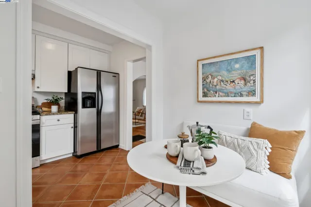 a dining room with furniture and kitchen view