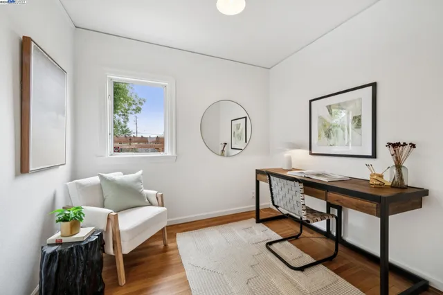 a view of a workspace with furniture and wooden floor