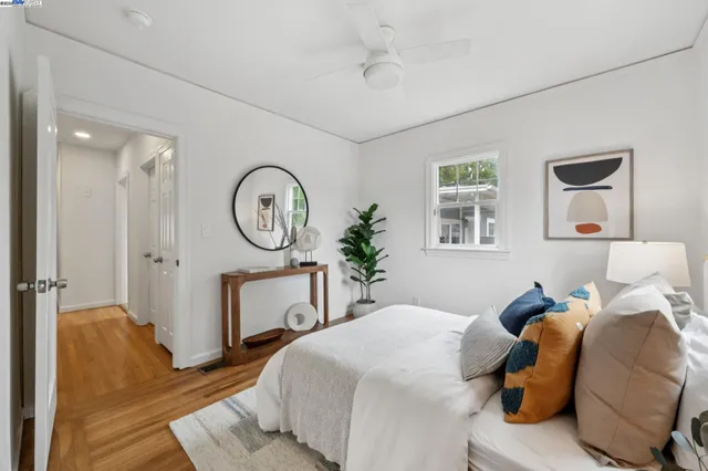 a bedroom with a bed a mirror and a table