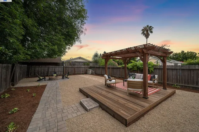 a view of a backyard with sitting area