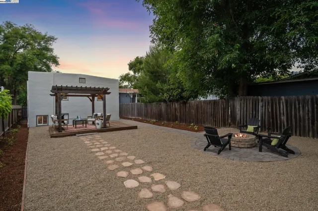 a view of a backyard with sitting area and furniture