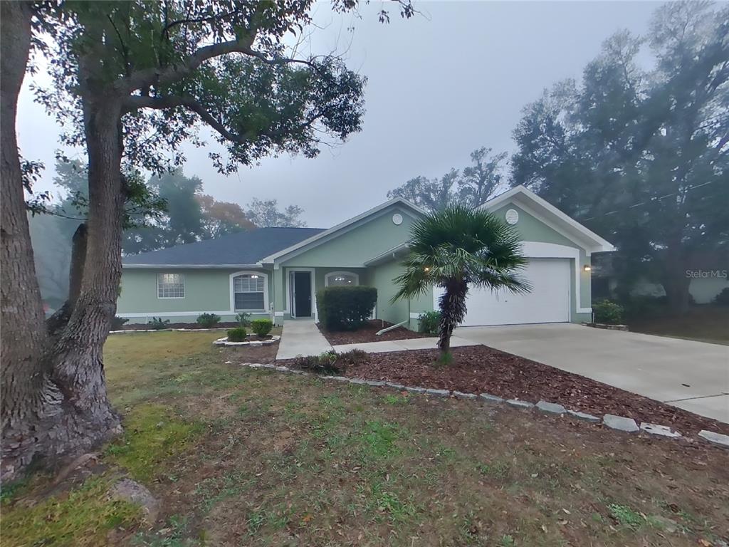 Undisclosed Address Spring Hill, FL 34608 - Photo 1 of 1 a house that has a tree in front of it