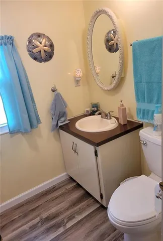a bathroom with a toilet mirror and vanity