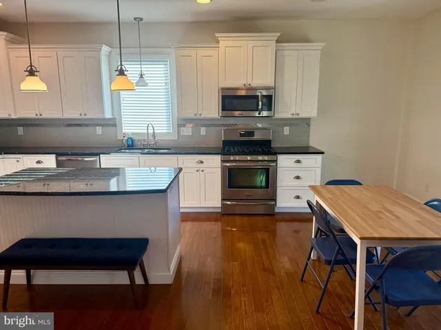 a kitchen with stainless steel appliances granite countertop a stove a sink dishwasher a microwave oven with granite countertops and cabinets