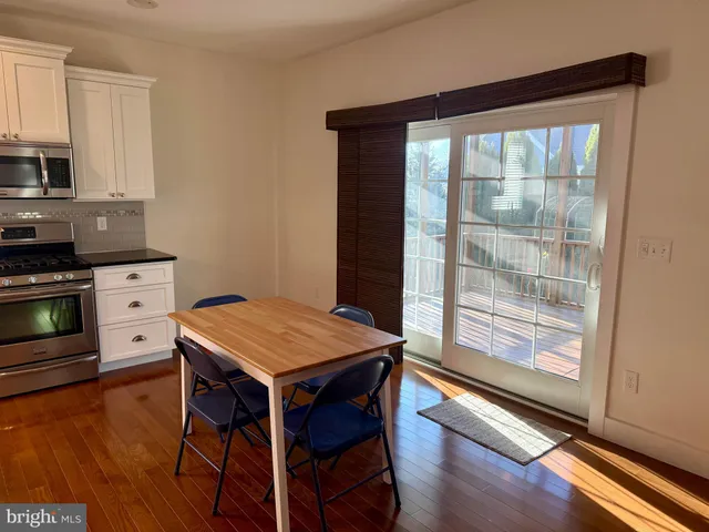 a room with wooden floor and furniture