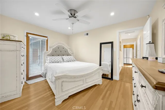 a spacious bedroom with a bed and a chandelier