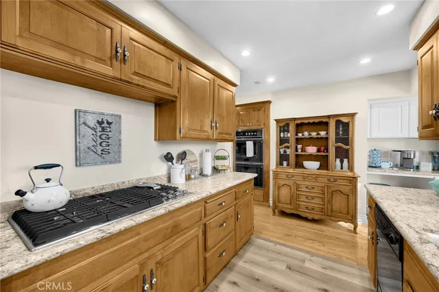 a kitchen with stainless steel appliances granite countertop a stove and cabinets
