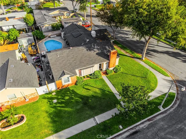 an aerial view of a house with a garden and swimming pool
