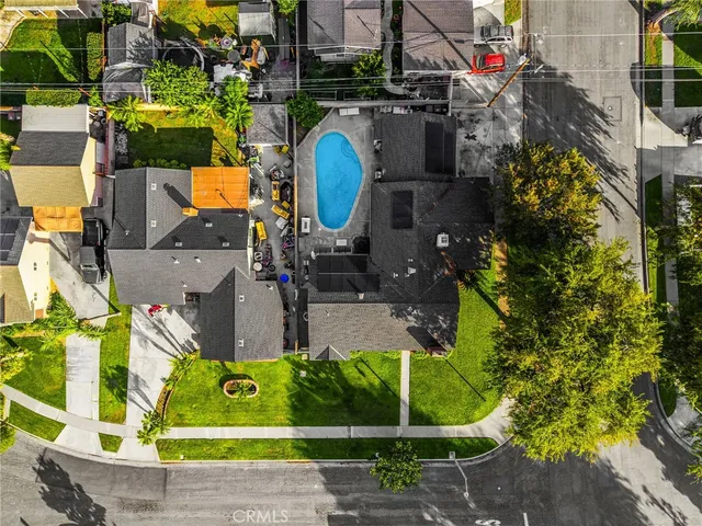 an aerial view of a house with a swimming pool