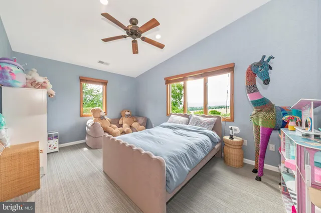 a living room with furniture and a book shelf
