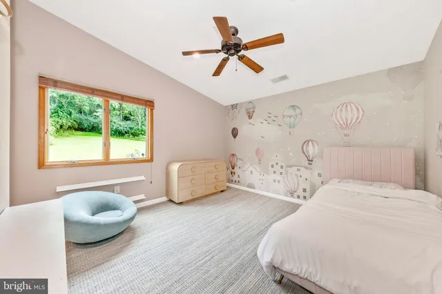 a bedroom with two beds and painting on the wall