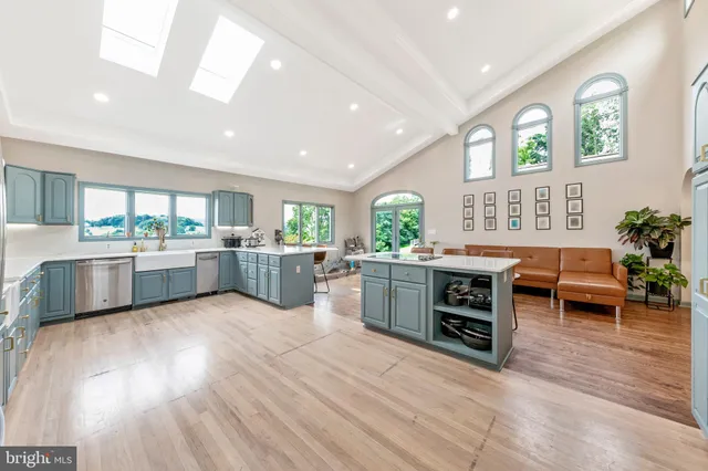 a large kitchen with a table and chairs in it