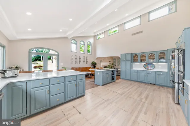 a large kitchen with stainless steel appliances lots of counter space and a sink