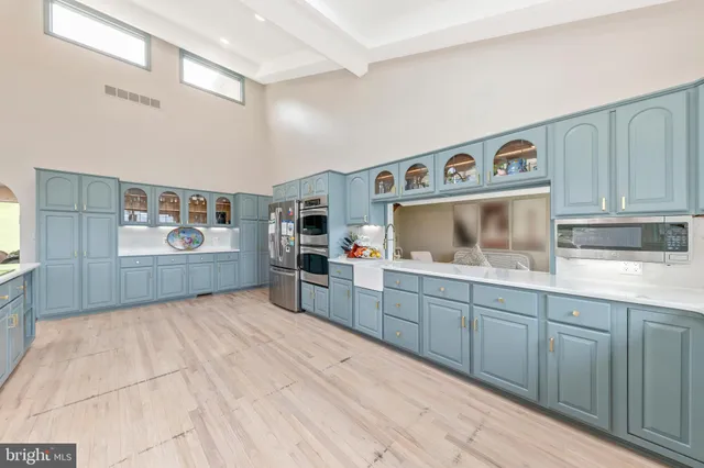 a kitchen with stainless steel appliances granite countertop a sink and cabinets