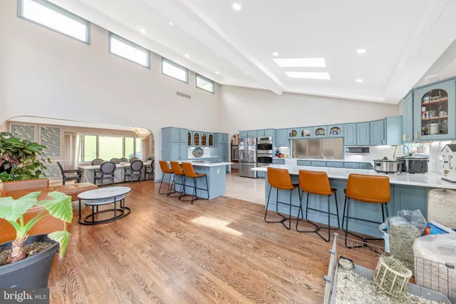 a living room with furniture and kitchen view