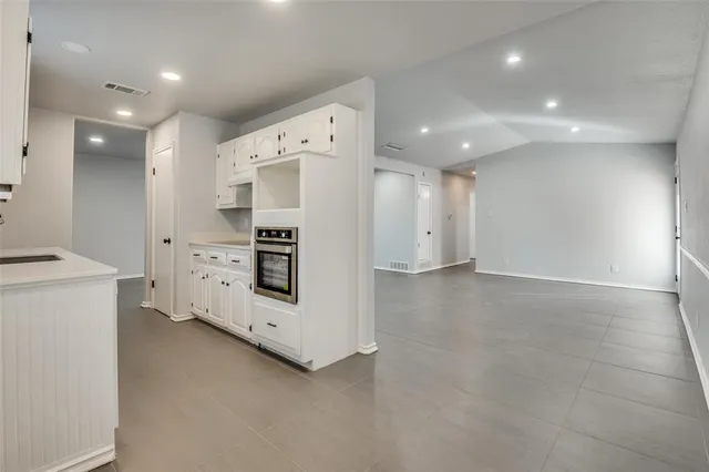a view of kitchen with stainless steel appliances a refrigerator and cabinets