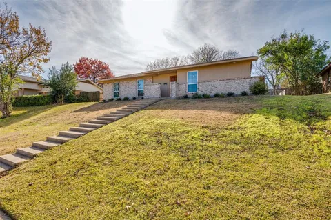 a view of back yard with wooden fence