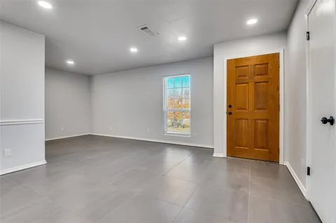 an empty room with windows and closet