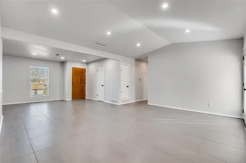 an empty room with closet and natural light