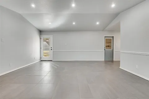 an empty room with a empty space and windows