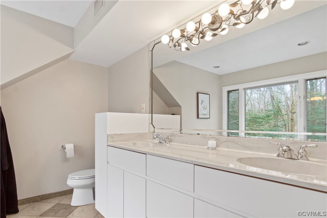 103 Overlook Drive Williamsburg, VA 23185 - Photo 30 of 50 a bathroom with a granite countertop sink a toilet and a large mirror