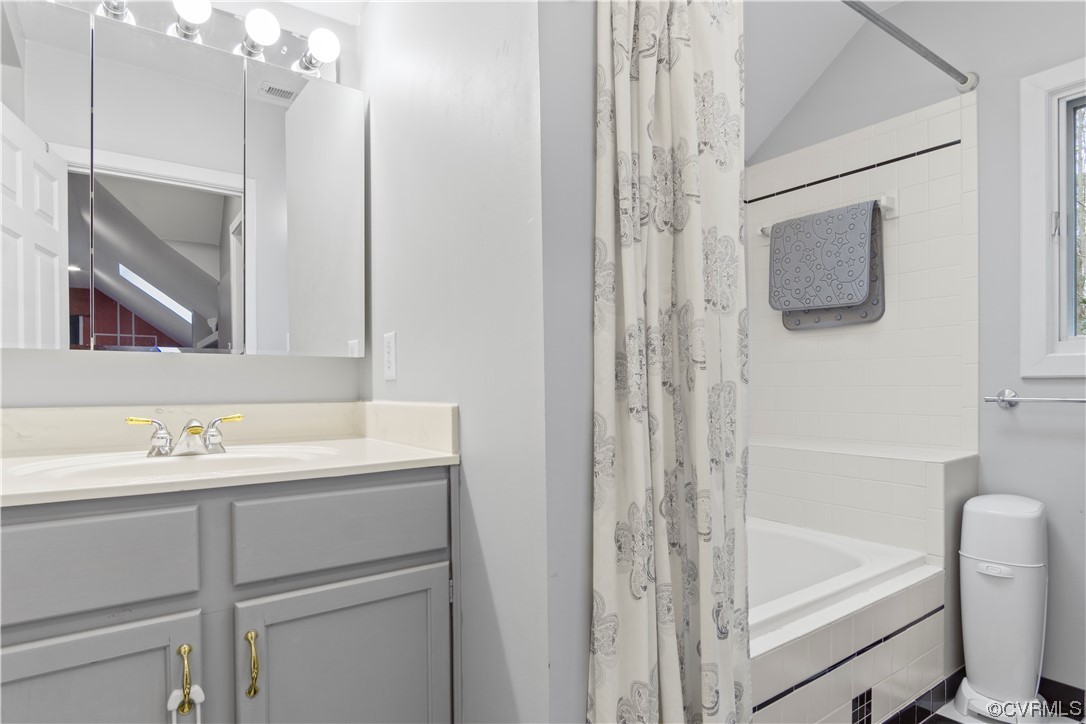 103 Overlook Drive Williamsburg, VA 23185 - Photo 36 of 50 a bathroom with a sink a large mirror and a bathtub