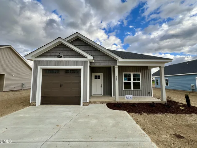 a front view of a house with a yard and garage