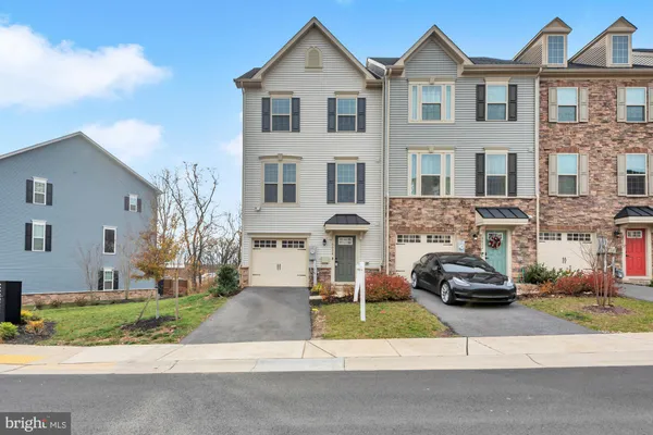 a front view of a house with a yard and plants