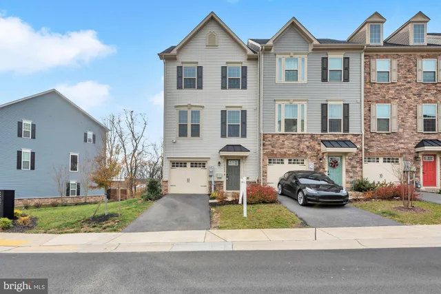 a front view of a house with a yard and plants