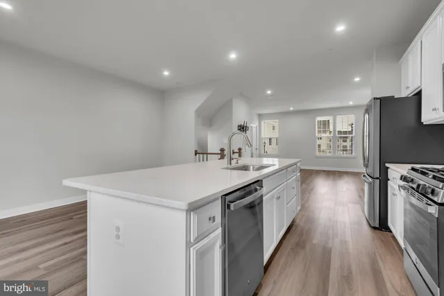 a kitchen with a sink stove and refrigerator