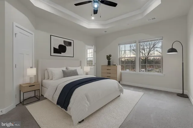 a spacious bedroom with a bed and a window