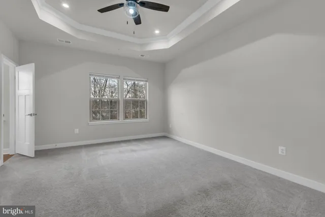 an empty room with a empty space and windows