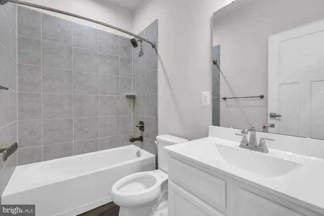 a bathroom with a sink a toilet and a bathtub