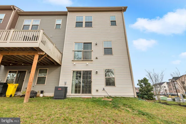 a front view of a house with a yard and potted plants