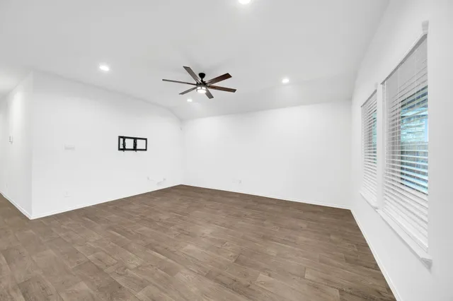 wooden floor in an empty room with a window