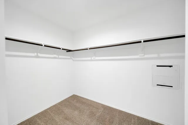 an empty room with window and ceiling fan